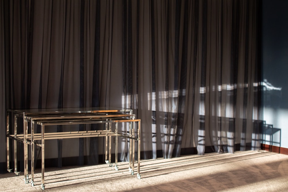 a couple of tables sitting in front of a curtain