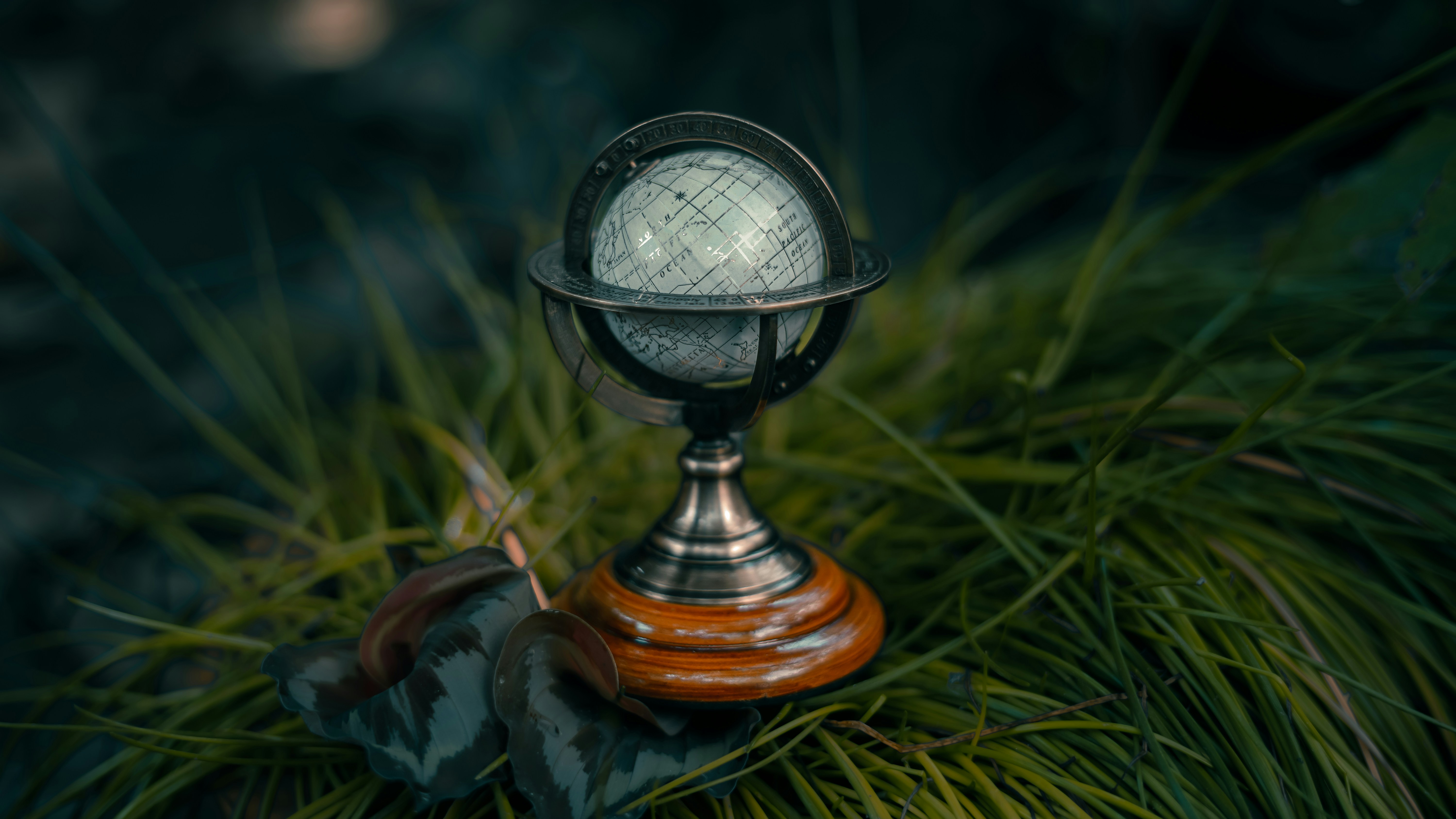 a small globe sitting on top of a wooden stand