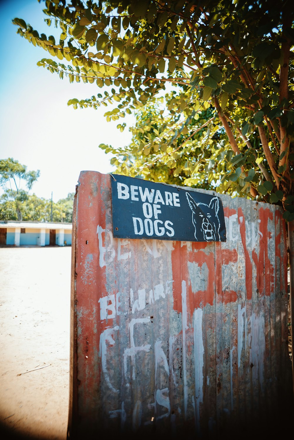 a rusted metal box with a sign that says beware of dogs