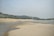 A serene river landscape with people brainstorming ideas on a notepad by the water's edge.