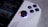 Close-up of a casual gamer enjoying a video game on a handheld device.