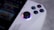Close-up of a casual gamer enjoying a video game on a handheld device.