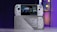 A handheld gaming console with a screen displaying a game library menu is placed on top of its packaging. The console features various buttons, a joystick, and a circular light around the left joystick. The background is blurred with purple, yellow, and blue tones.