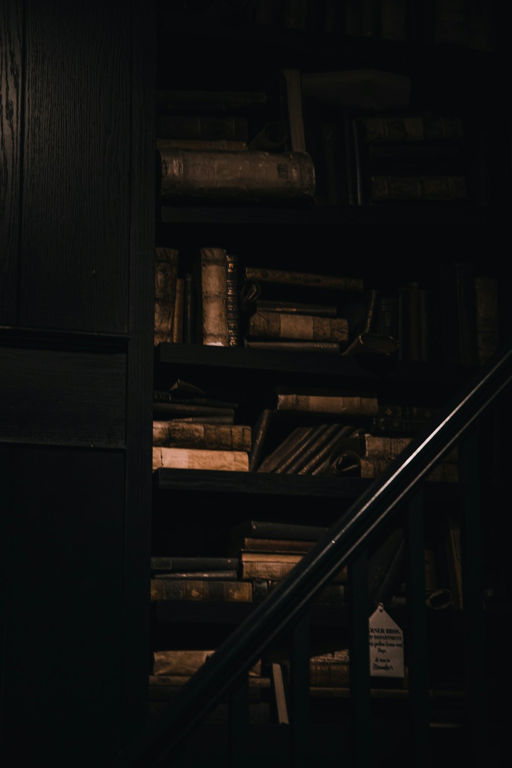 a staircase leading to a bookshelf full of books