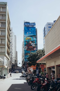 A vibrant street scene in Hilo with colorful murals and locals enjoying a sunny day.