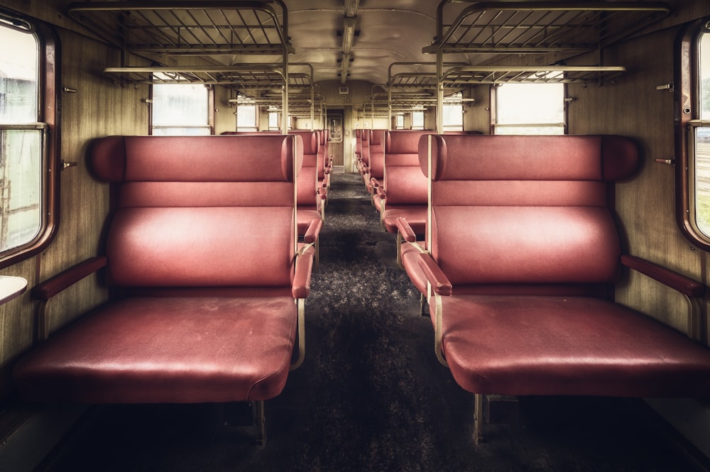 a train car with red seats and windows