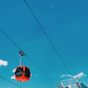 a red ski lift going up a hill