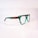 A pair of eyeglasses with a distinctive design, featuring green transparent frames with brown tortoiseshell accents on the temples. The glasses are set against a plain, soft-focus background, highlighting their stylish and modern appearance.
