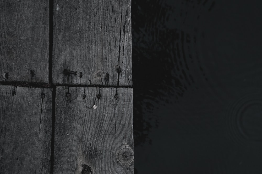 a black and white photo of a wooden dock
