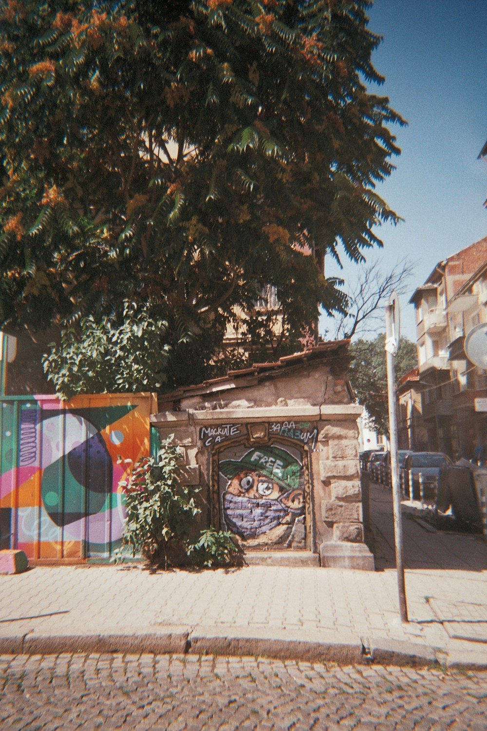 a building with a colorful gate on the side of it