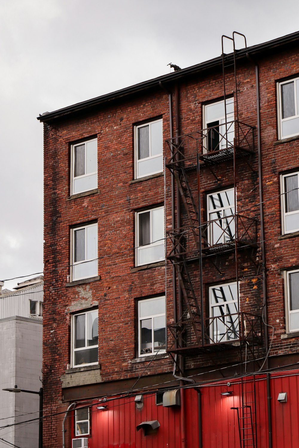 a tall red brick building with a fire escape
