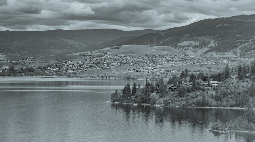 a black and white photo of a lake surrounded by mountains