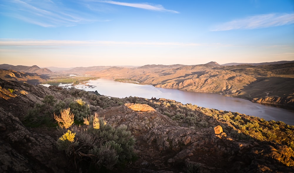 a scenic view of a lake surrounded by mountains