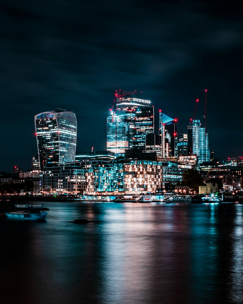 the city of london at night is lit up