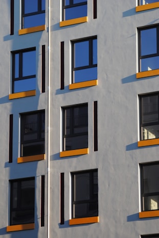 Completed residential building facade with yellow and black accents reflecting Selif Yapı branding.
