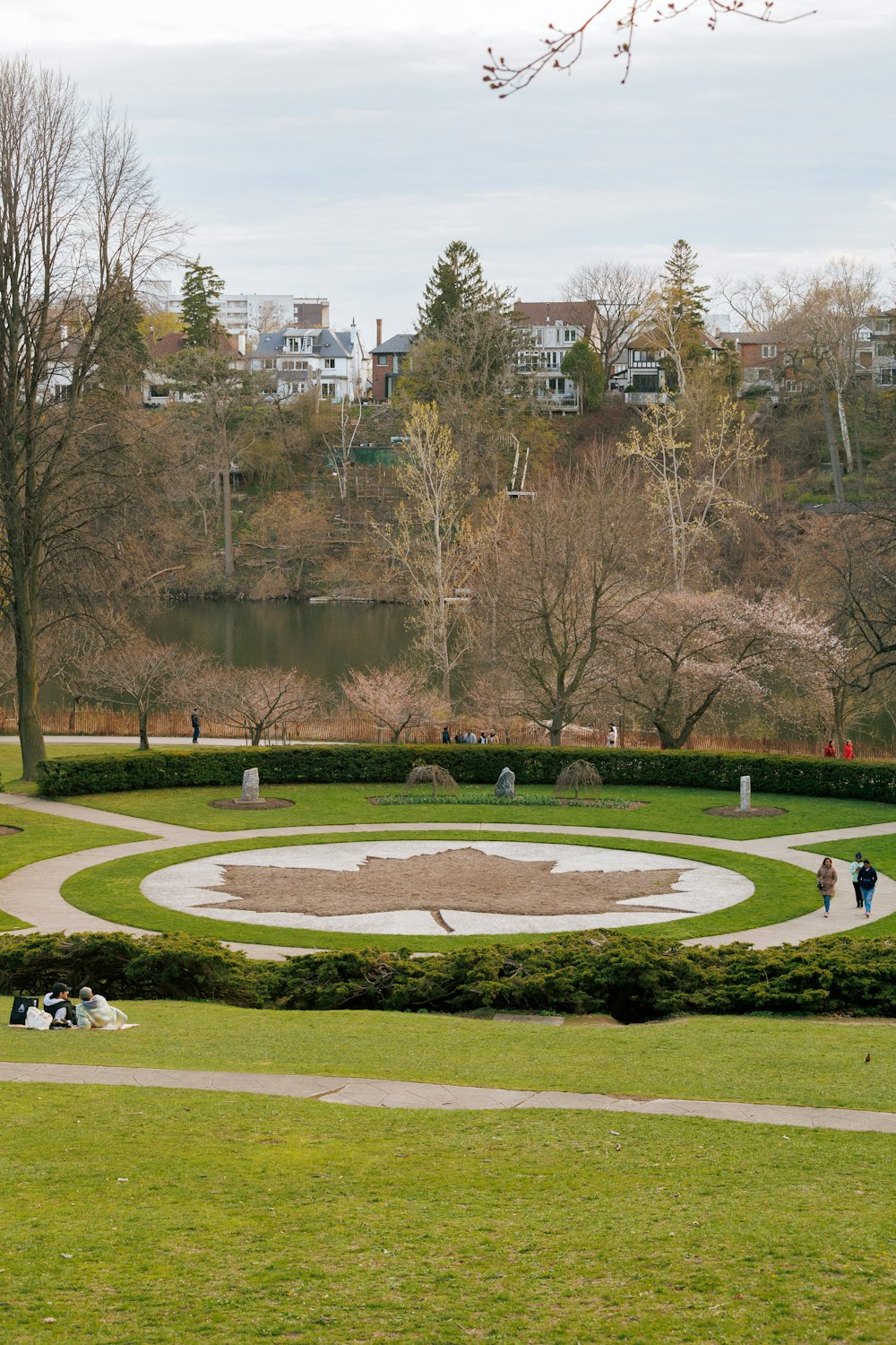 a group of people sitting on a bench in a park