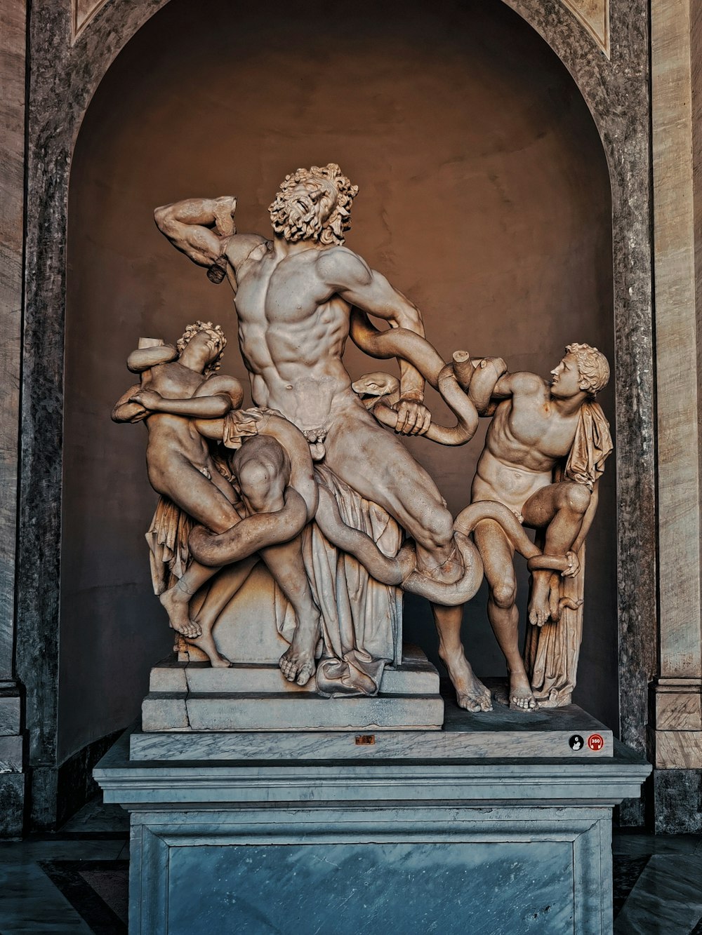 a statue of a man surrounded by men