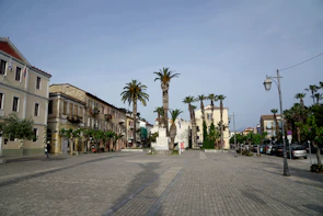A seaside town square where Latin American colonial architecture meets traditional Islamic art motifs.