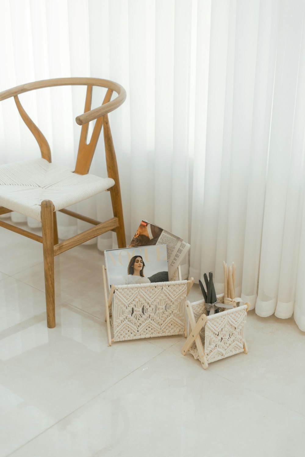 a white chair and a white chair with a magazine rack on the floor