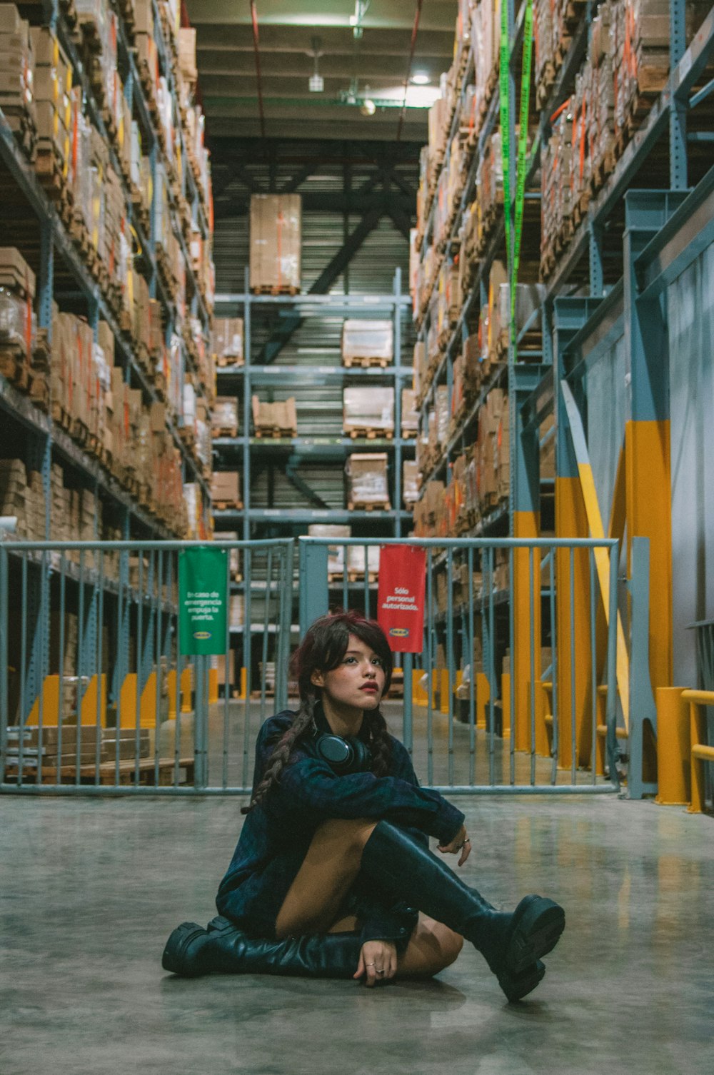a woman sitting on the floor in a warehouse