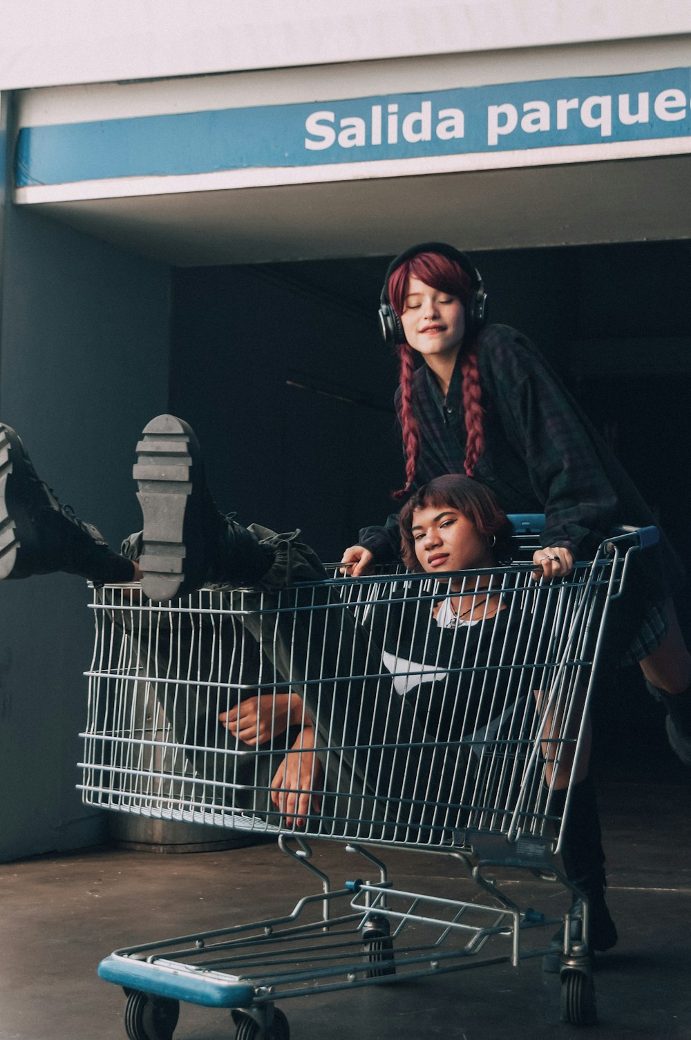 a woman and a child sitting in a shopping cart