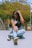 a woman sitting on the ground in ripped jeans