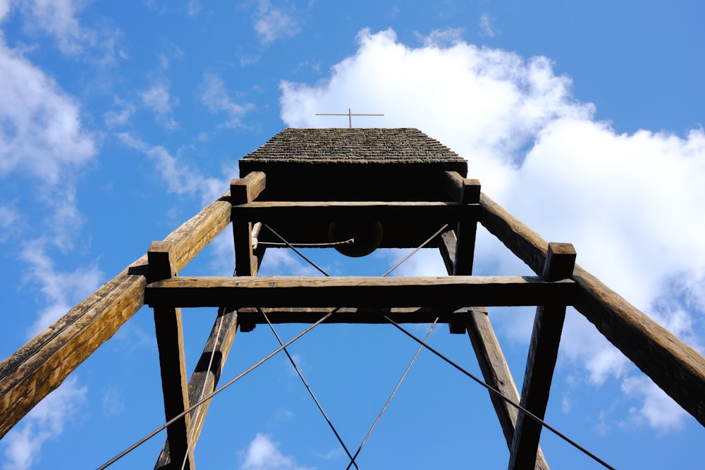 a tall wooden tower with a sky in the background