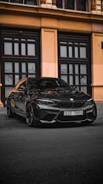 A sleek black car waiting outside Miami International Airport terminal.