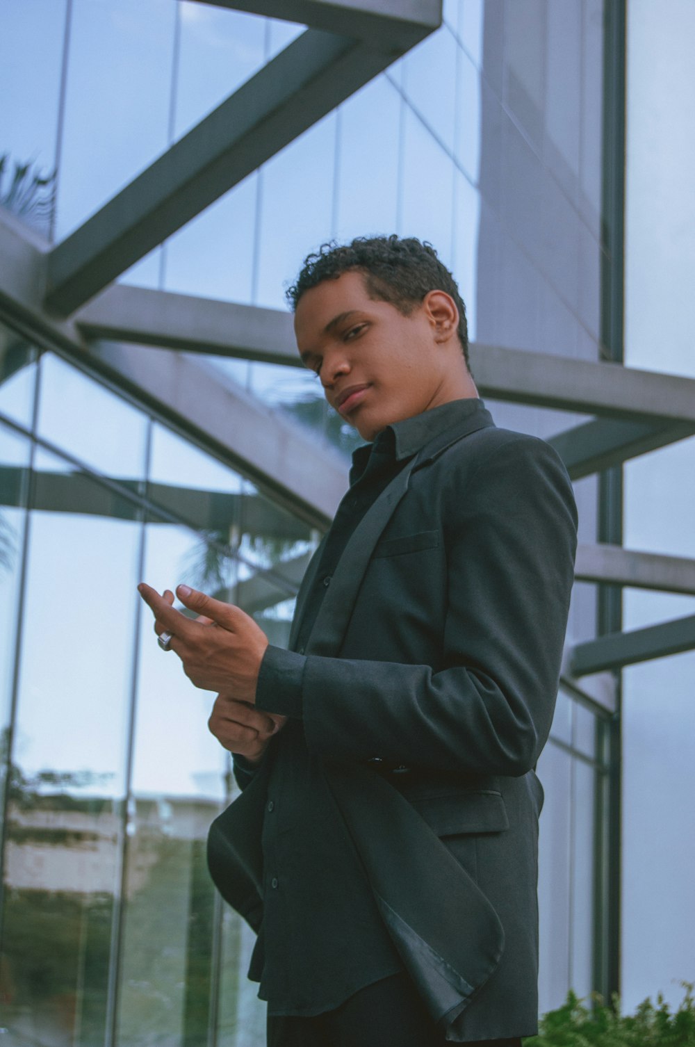 a man in a suit looking at his cell phone