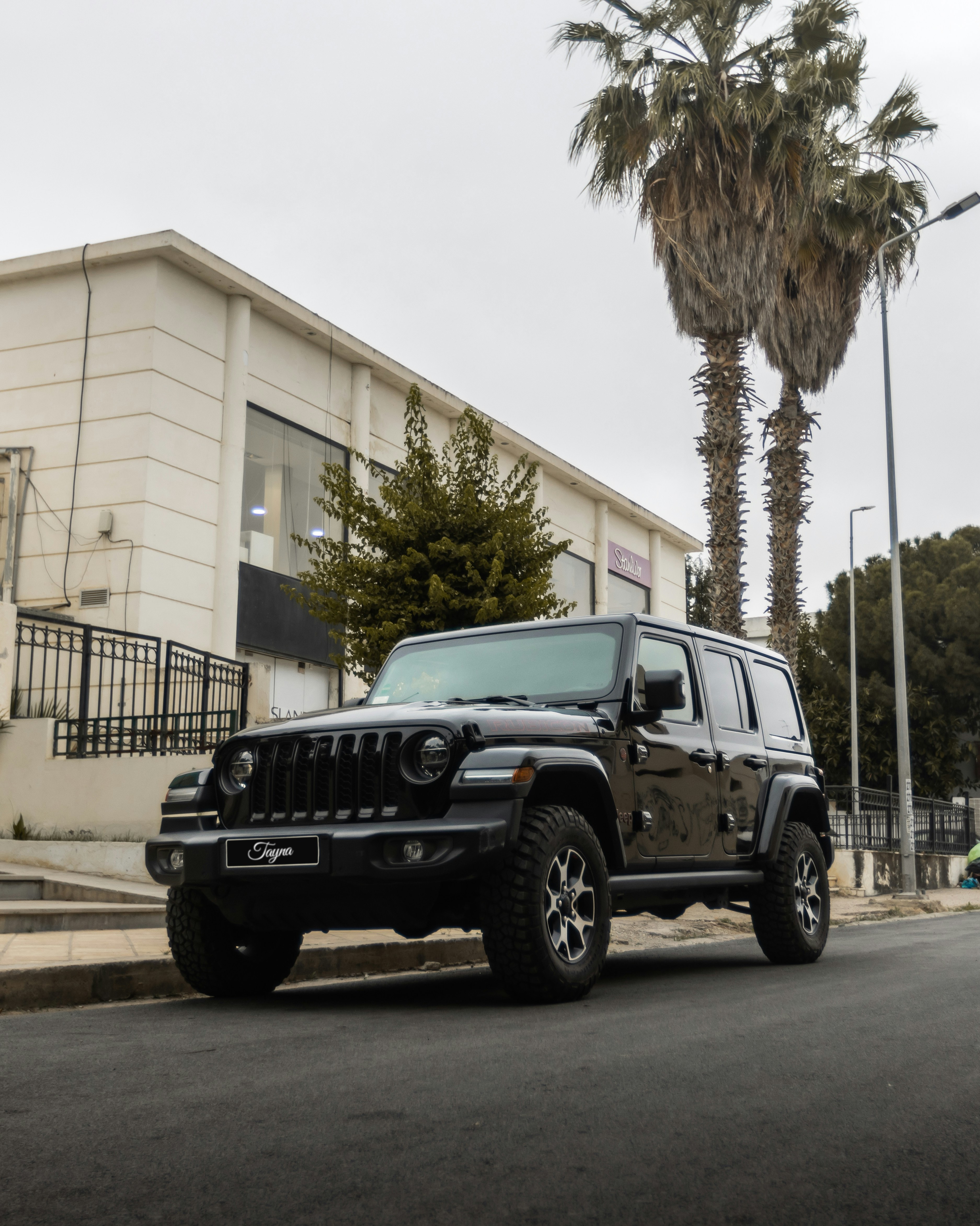 A black jeep parked on the side of the road photo – Free Jeep Image on ...