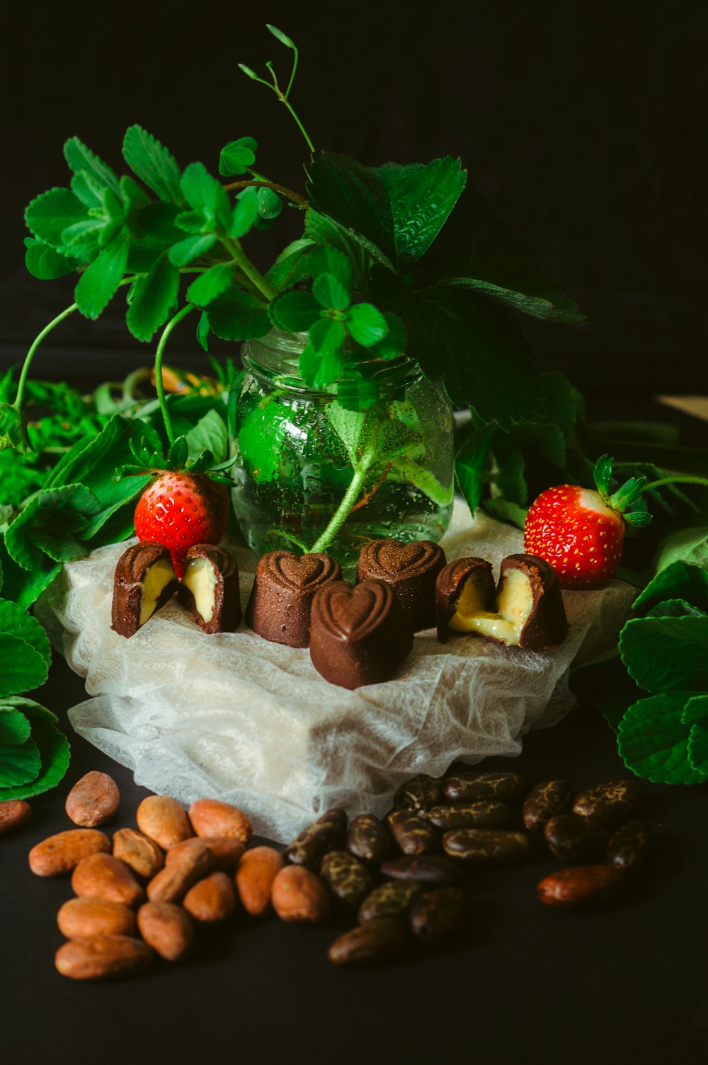 a glass vase filled with strawberries and chocolate