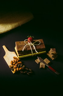 a wooden cutting board topped with pieces of chocolate