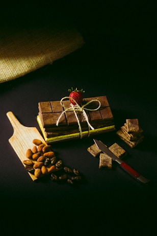 a wooden cutting board topped with pieces of chocolate