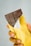 Close-up of a hand holding a beautifully wrapped chocolate from Hoppe Inc.