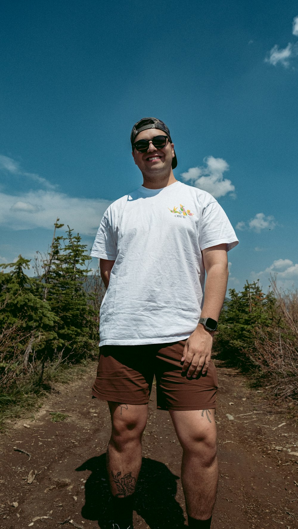 a man standing on top of a dirt road