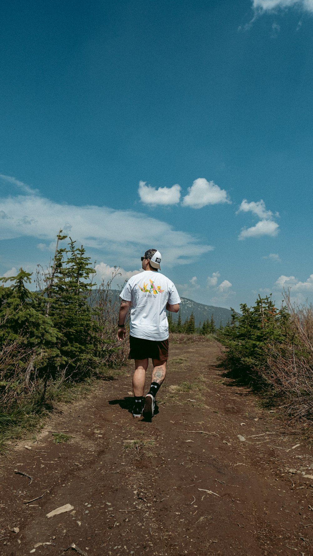 a man is running on a dirt path