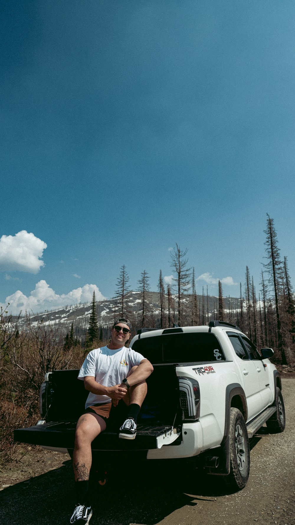 a man sitting on the back of a truck