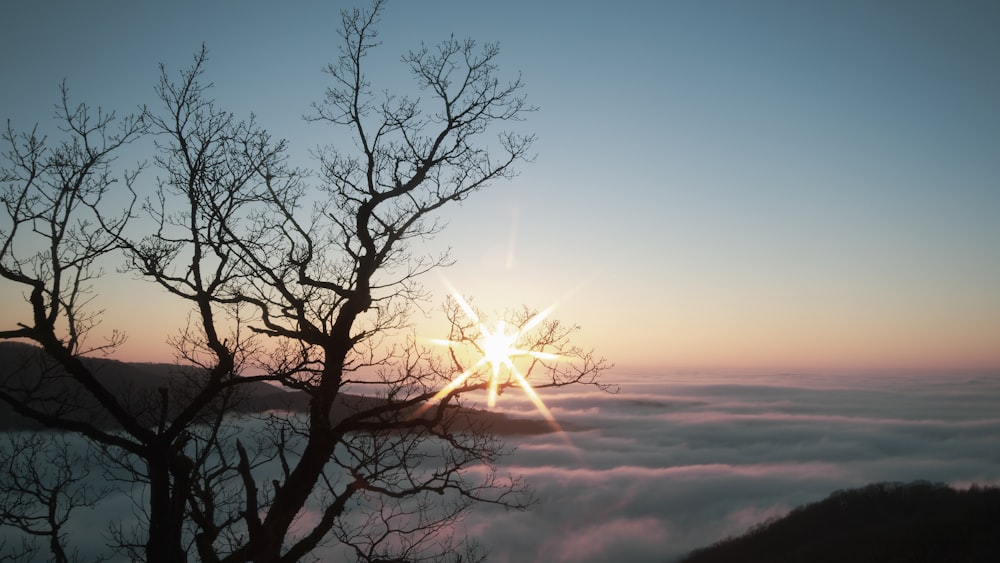 the sun is shining above the clouds in the sky