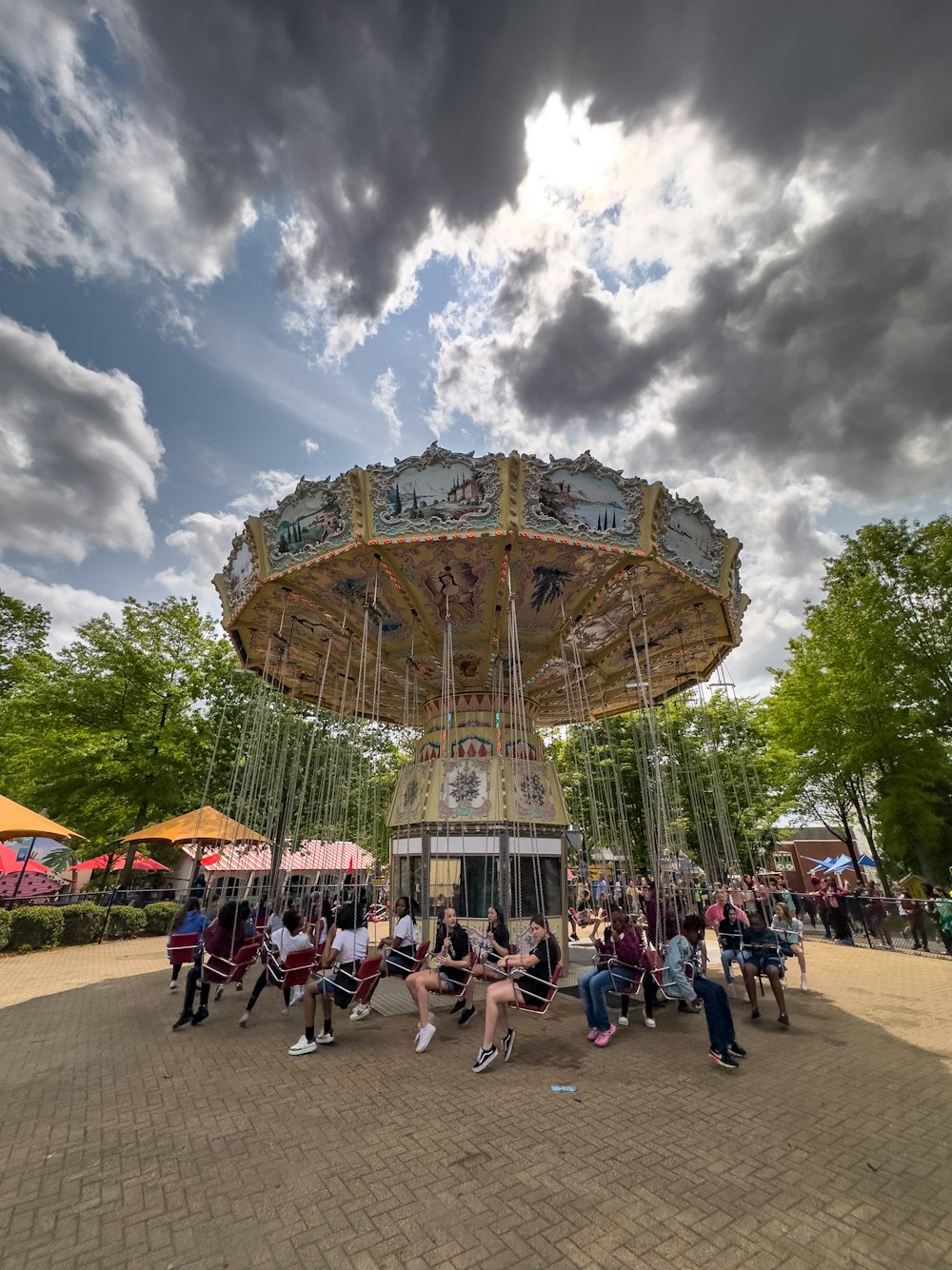 a group of people sitting around a merry go round