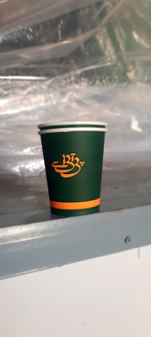 Custom printed plastic cup featuring a vibrant green Pantone #79df00 logo.