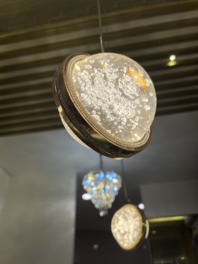 A sleek contemporary crystal ceiling light sparkling in a modern living room setting