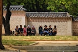 A group of diverse students practicing Korean conversation.
