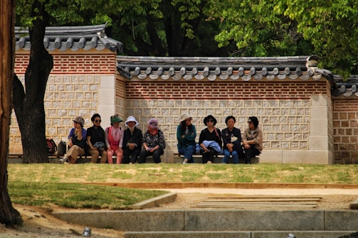 A group of diverse students practicing Korean conversation.