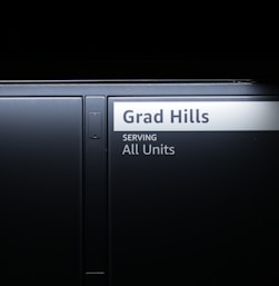 a black door with a sign that reads grad hills serving all units