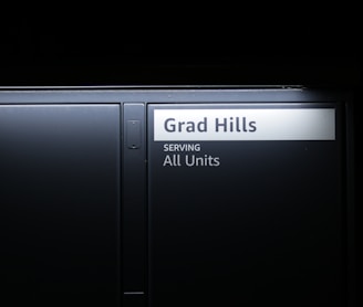 a black door with a sign that reads grad hills serving all units