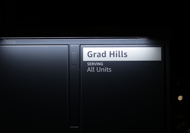 a black door with a sign that reads grad hills serving all units