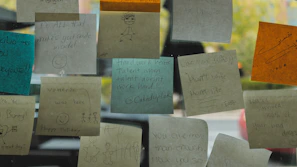 Colorful sticky notes on a wall with financial goals and motivational quotes.