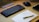 A professional workspace featuring a laptop and a notepad.