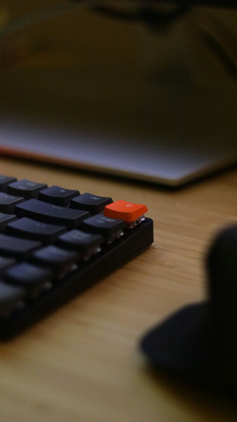 a computer keyboard sitting on top of a wooden desk