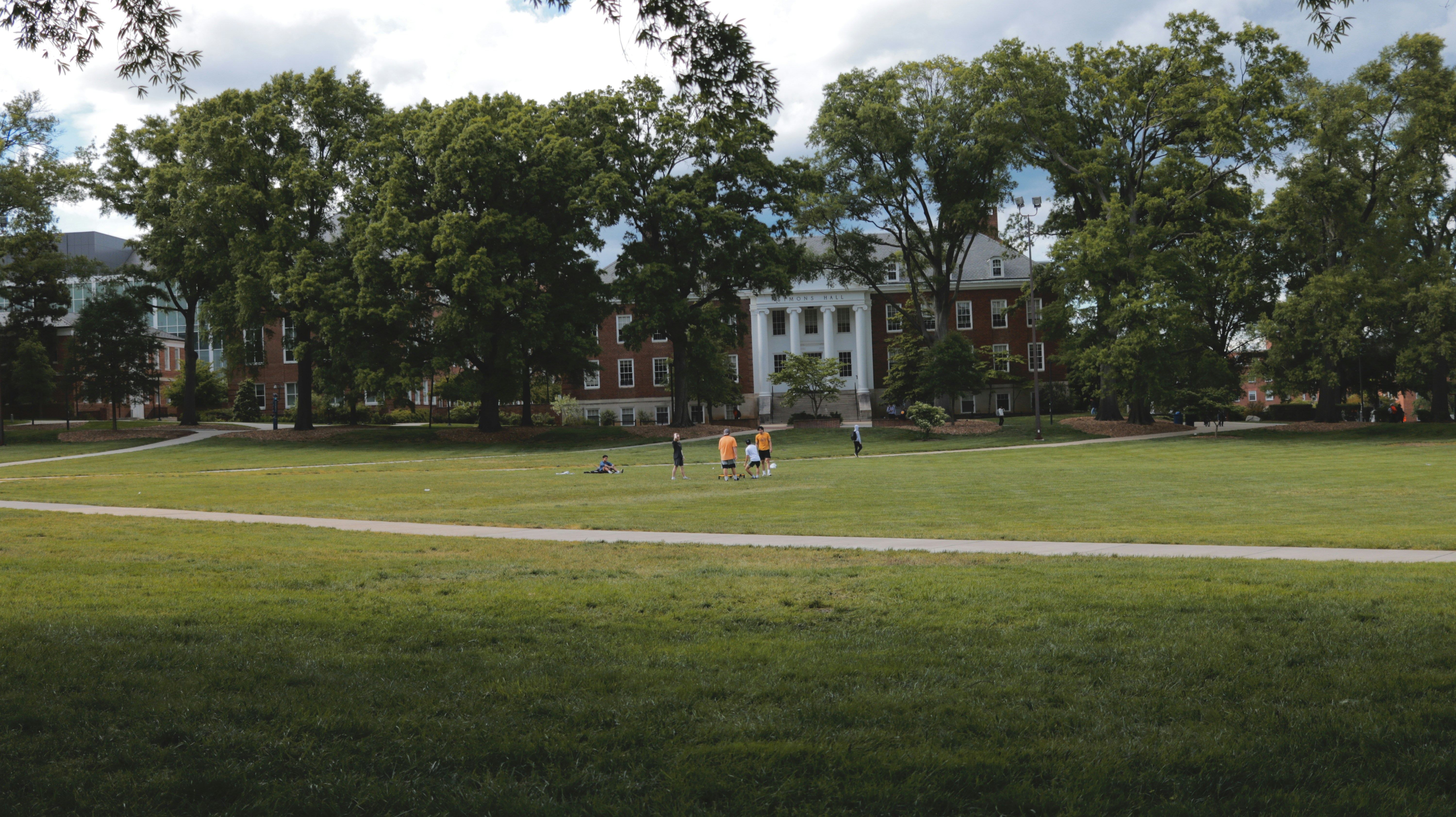 Students playing on the lawn of their university